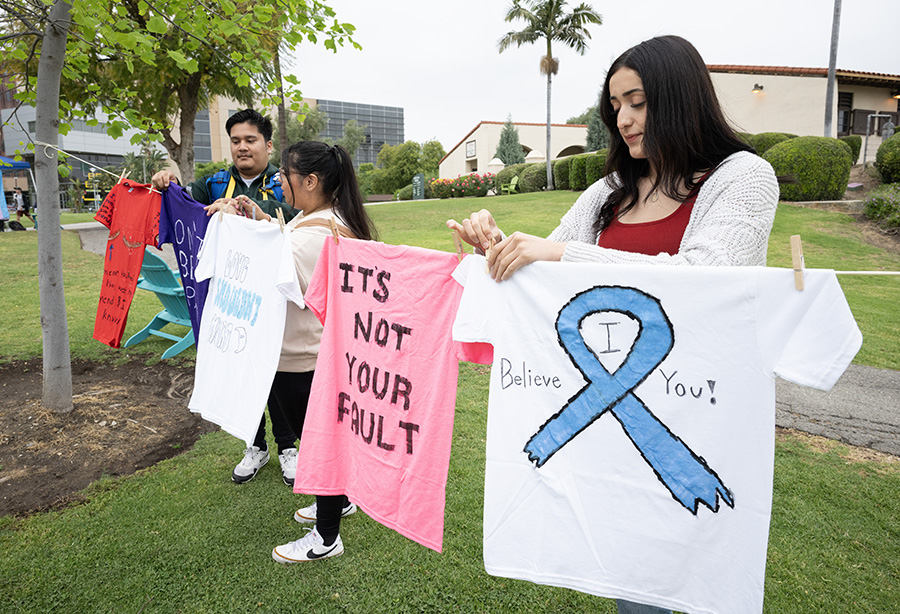 Photo of students hanging creative shirts