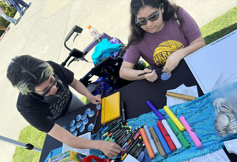 students making denim buttons