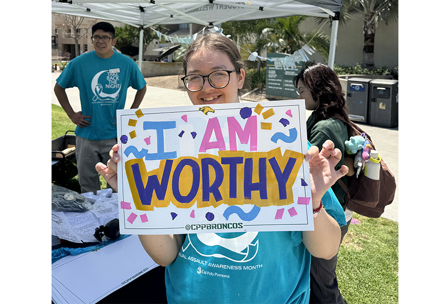 student with sign says I am worthy