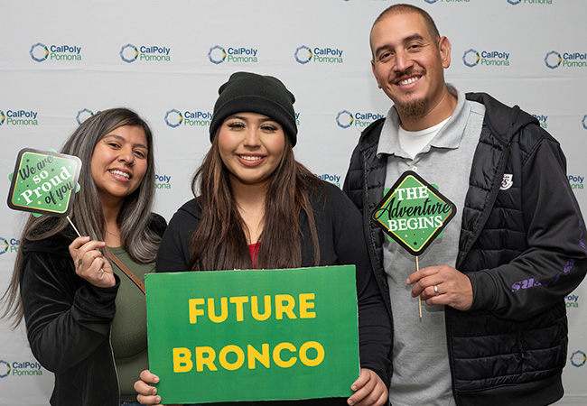 Parents pose with their daughter during BroncoBound 2024.