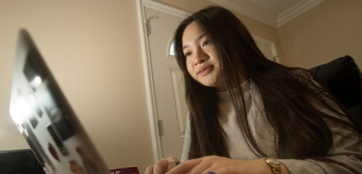 A student uses her laptop at home