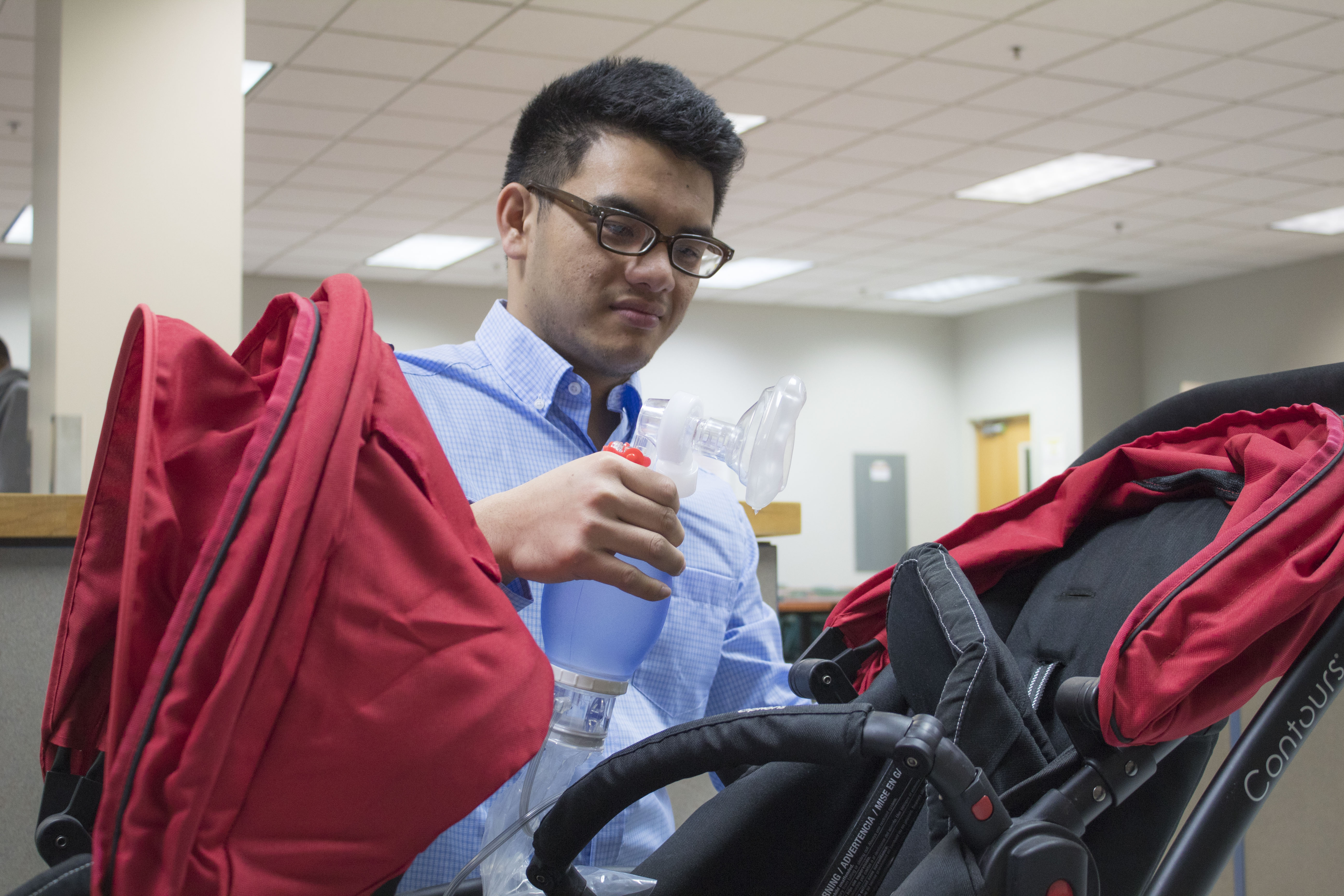 Male student holding an oxygen mask