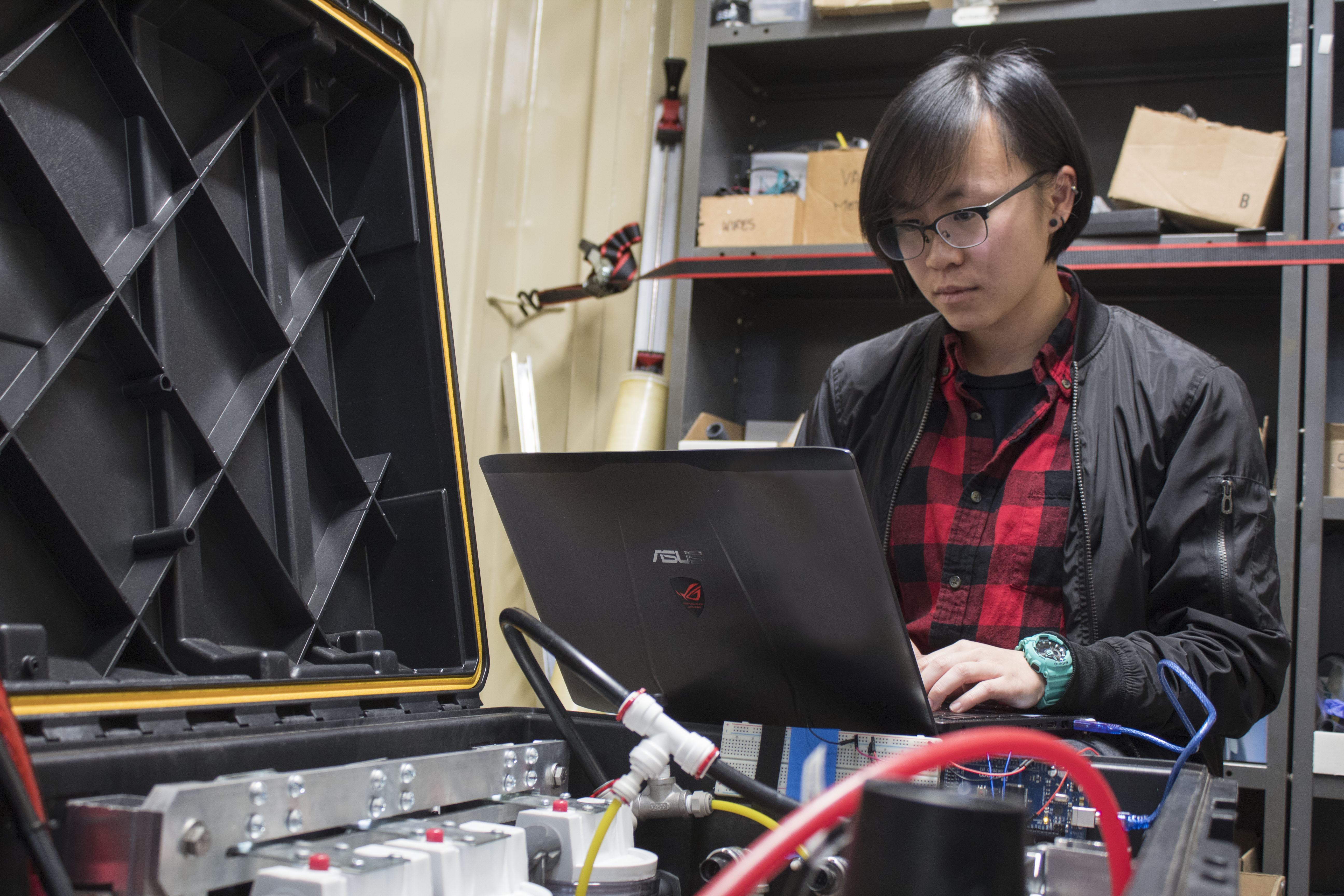 Female student in an engineering lab working on her laptop