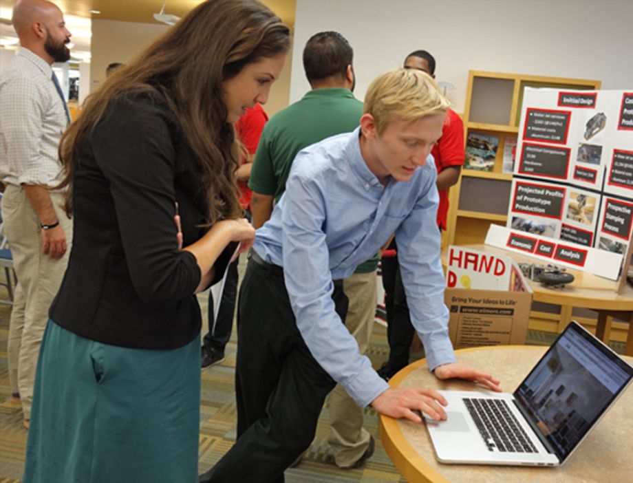 Student showing his project on his computer.