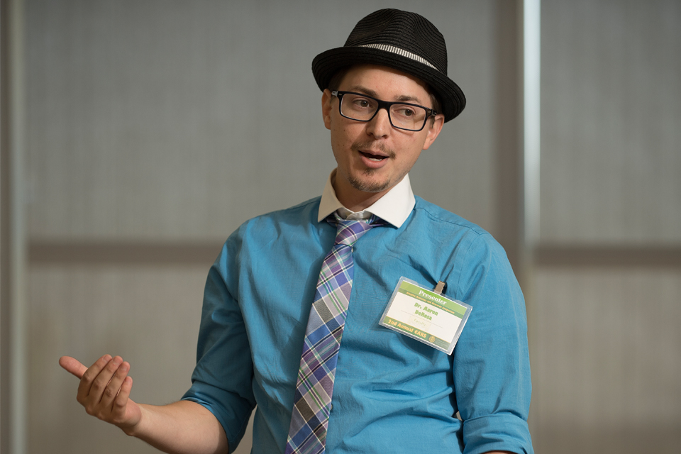 Man in blue shirt giving a presentation