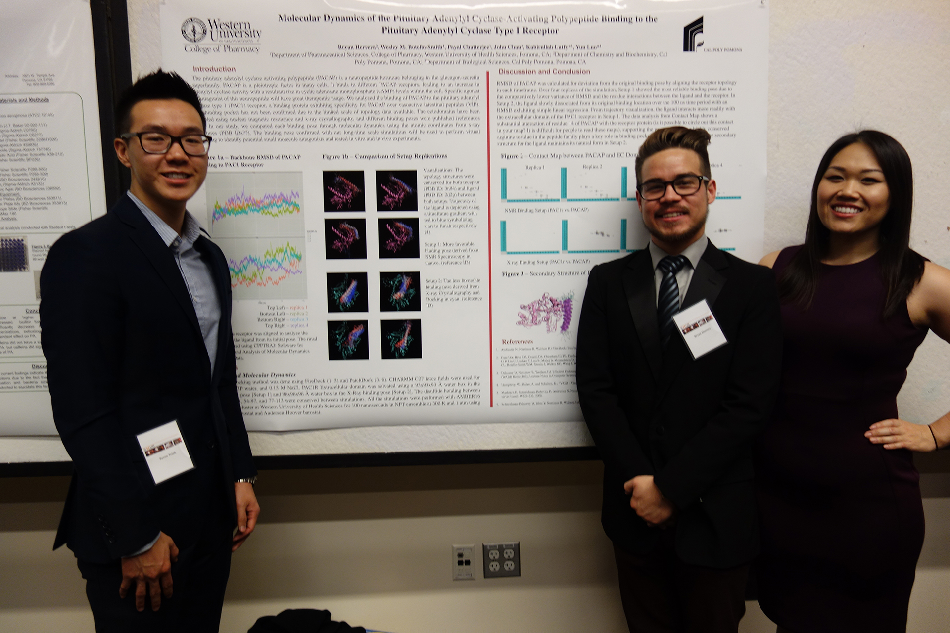 Three students posing in front of their research poster at conference
