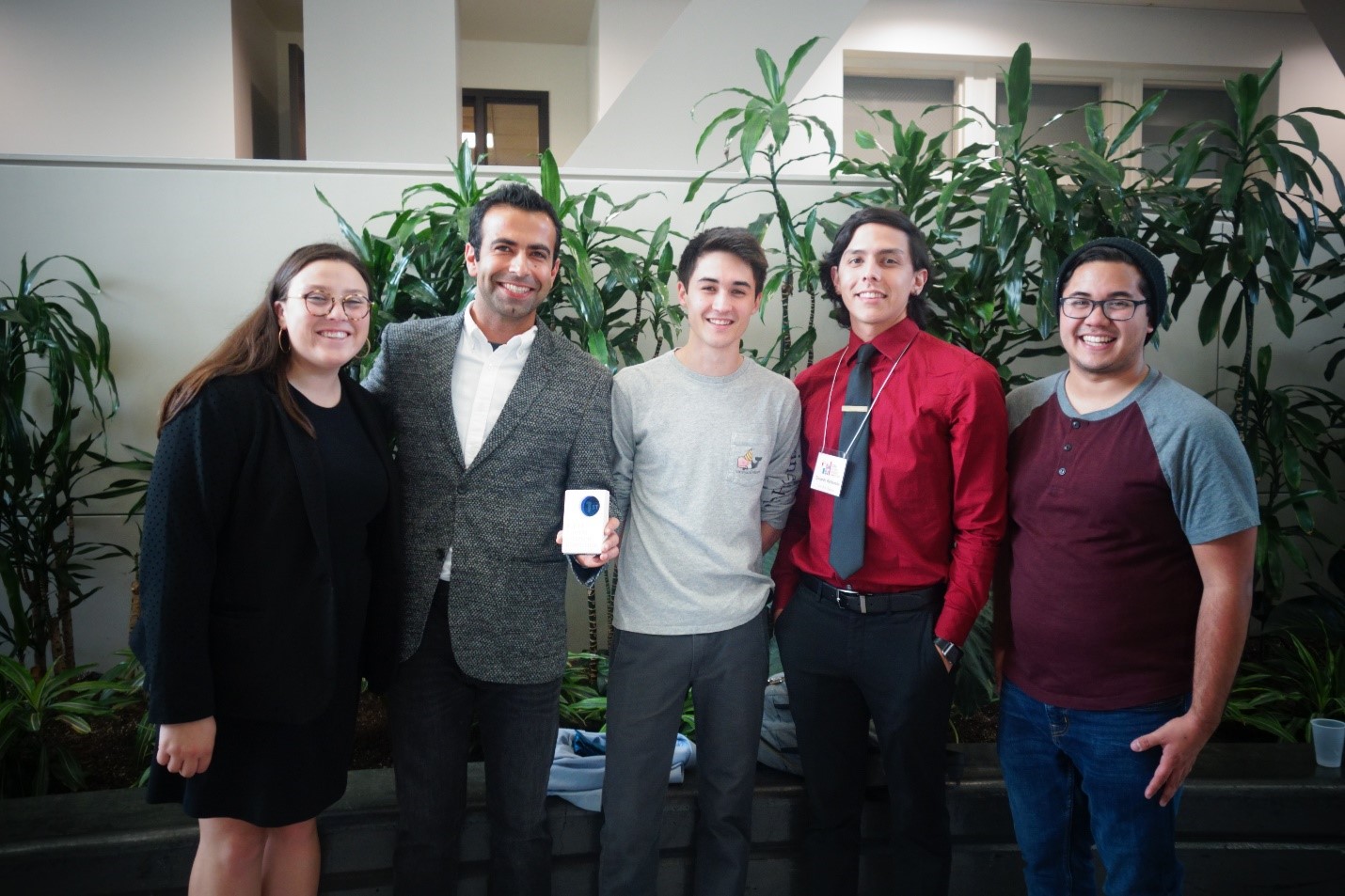 students holding award at research events