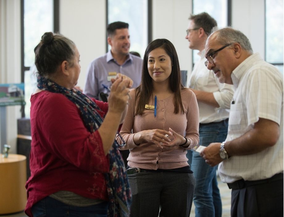 Faculty speaking to each other.