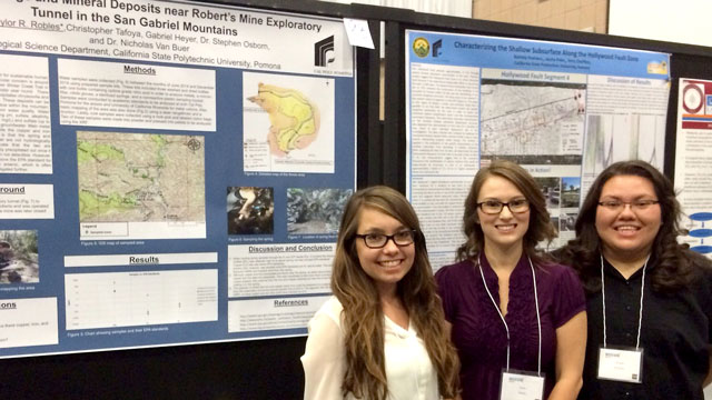 Students Brittany Curry, Taylor Robles and Nahtaly Pastrana stand in front of poster presentations at the conference.