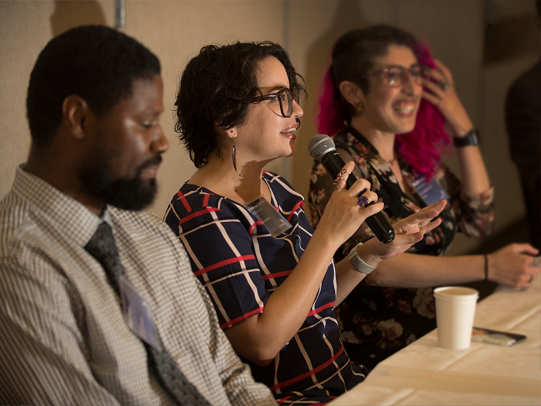 PhD students speaking at a panel