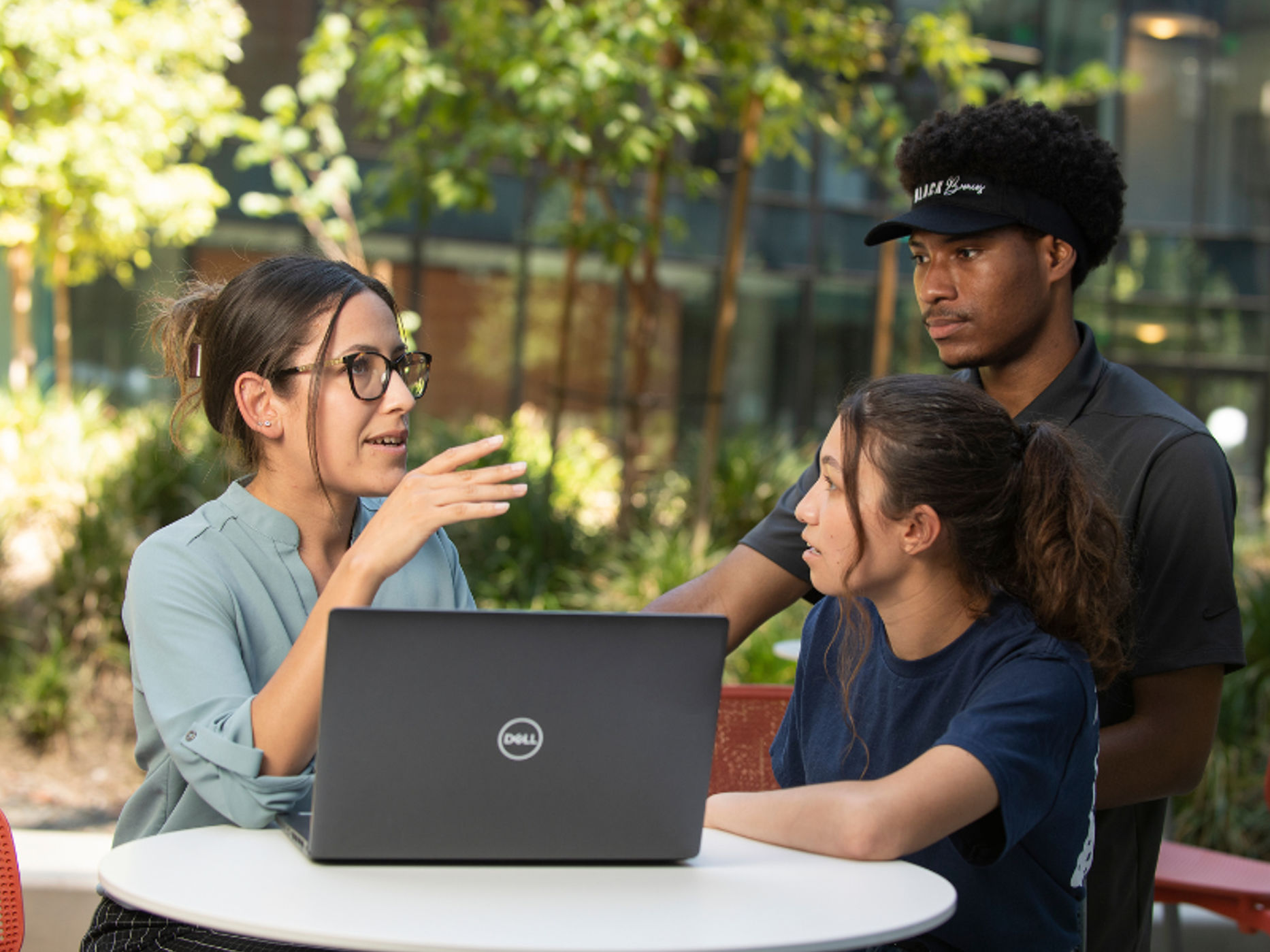 A faculty member guiding a group of students.