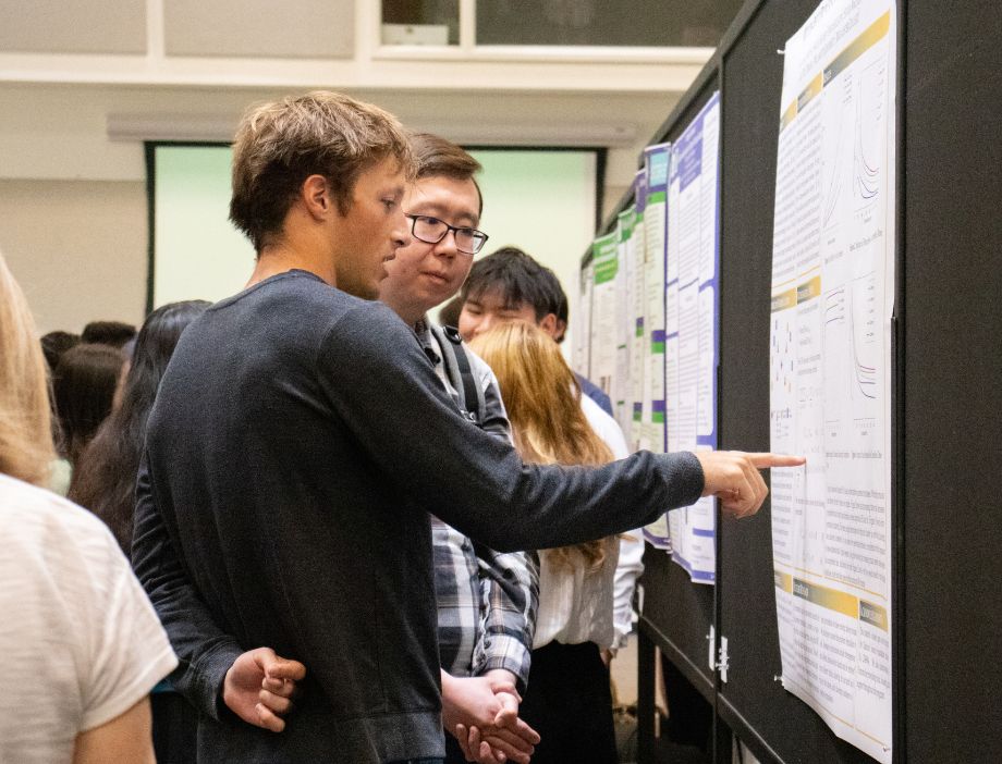 A student presenting his poster presentation at CARS.