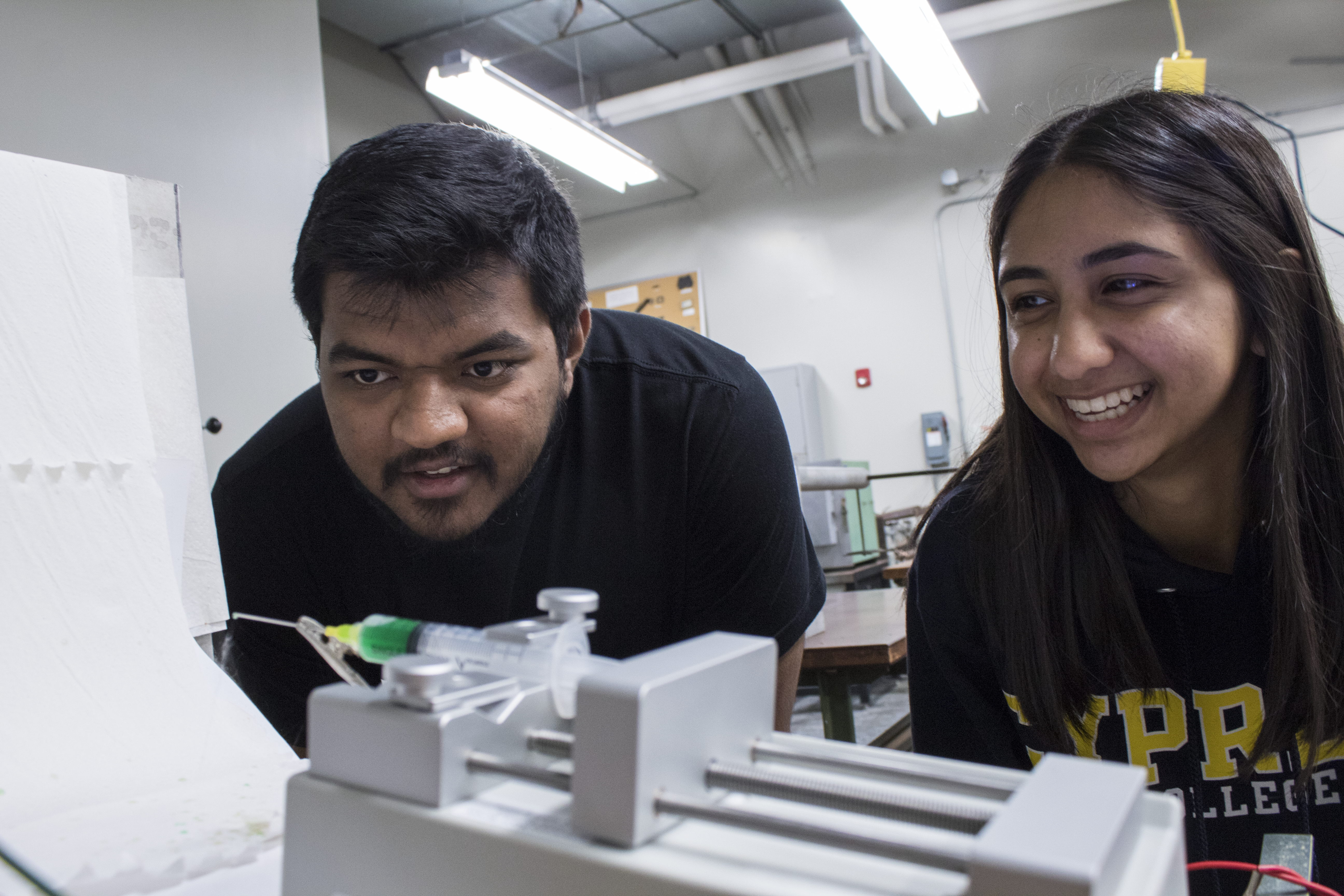 student and mentor in lab laughing