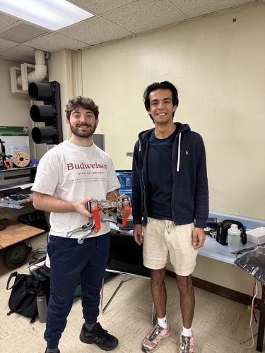 Members of Team ARC Lab holding their project