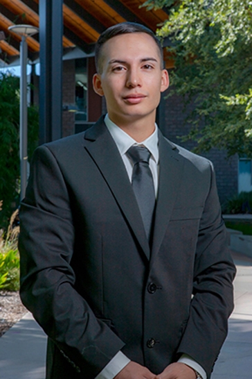 Student in a suit posing confidently
