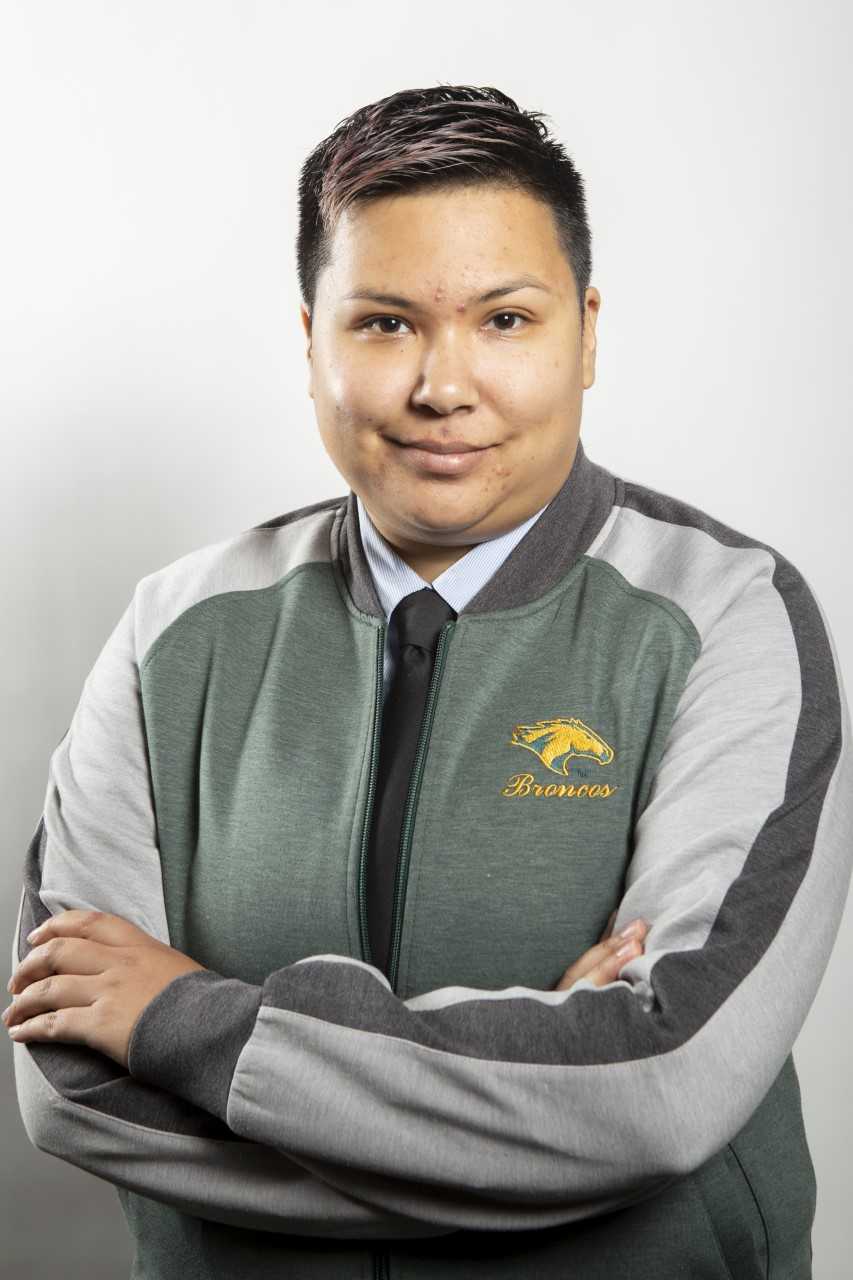 Student wearing a cal poly sweater and crossing their arms