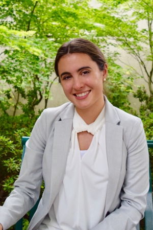 Female student in a blazer confidently posing 