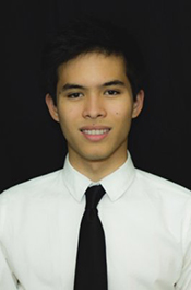 Male student in a shirt and tie confidently smiling