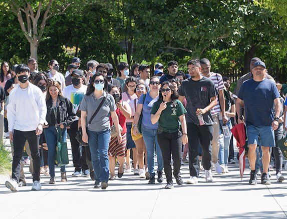 A group of people take a tour on campus