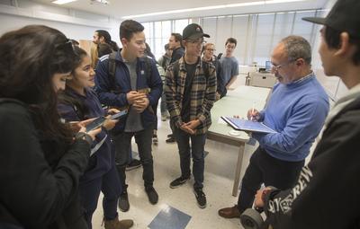 A professor speaking with some of his students