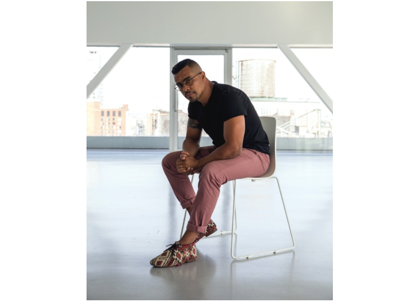 Photo of artist Shaun Leonardo seated in studio environment