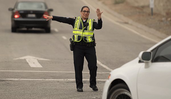 Gregory Brown of the Cal Poly Pomona police department has a cup of coffee with visitors