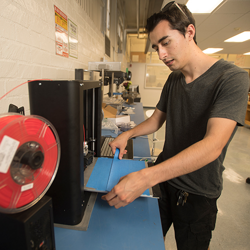 Student working with 3D printer