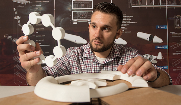 Student with prototype of mars habitat