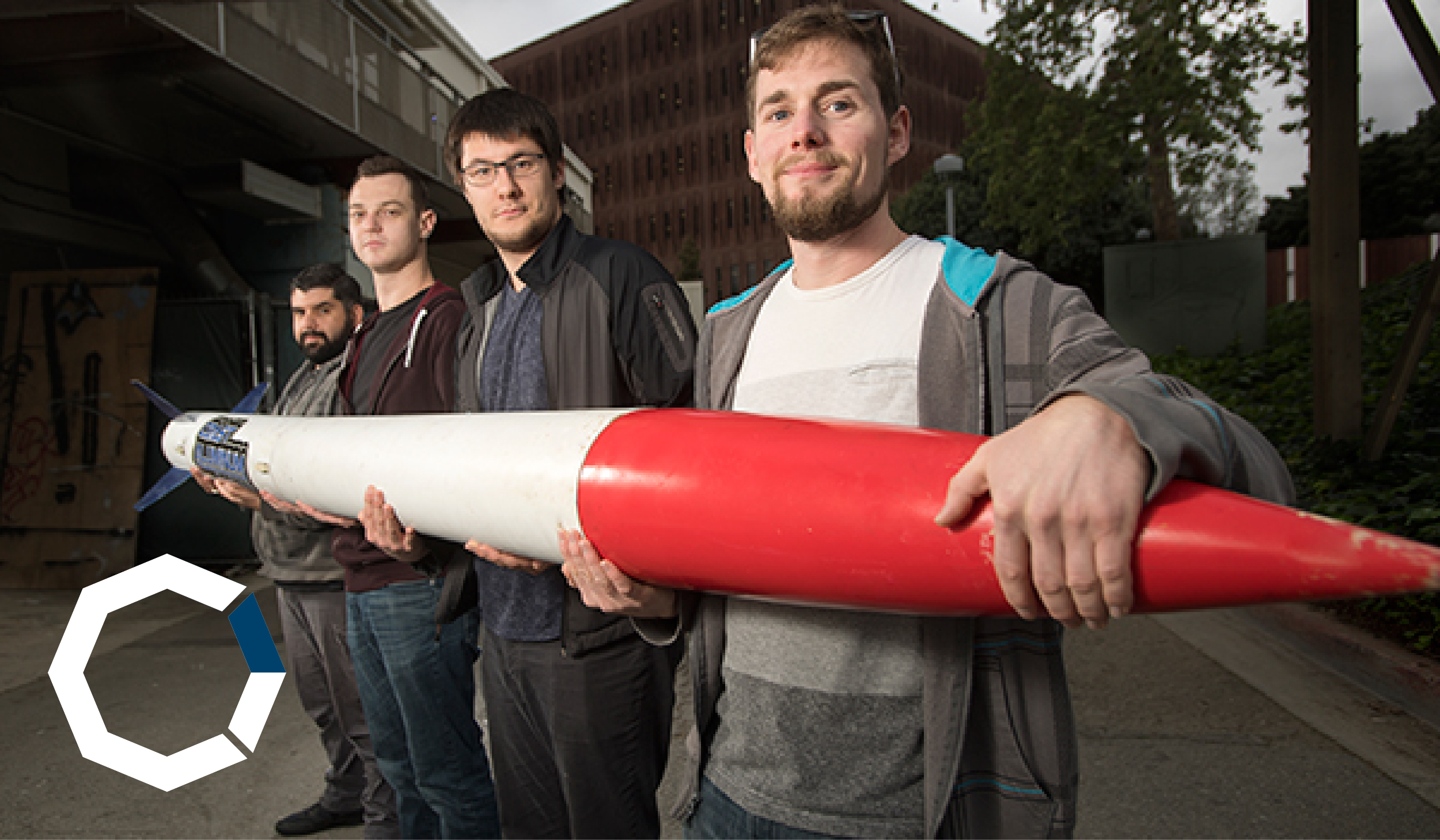 4 students holding rocket