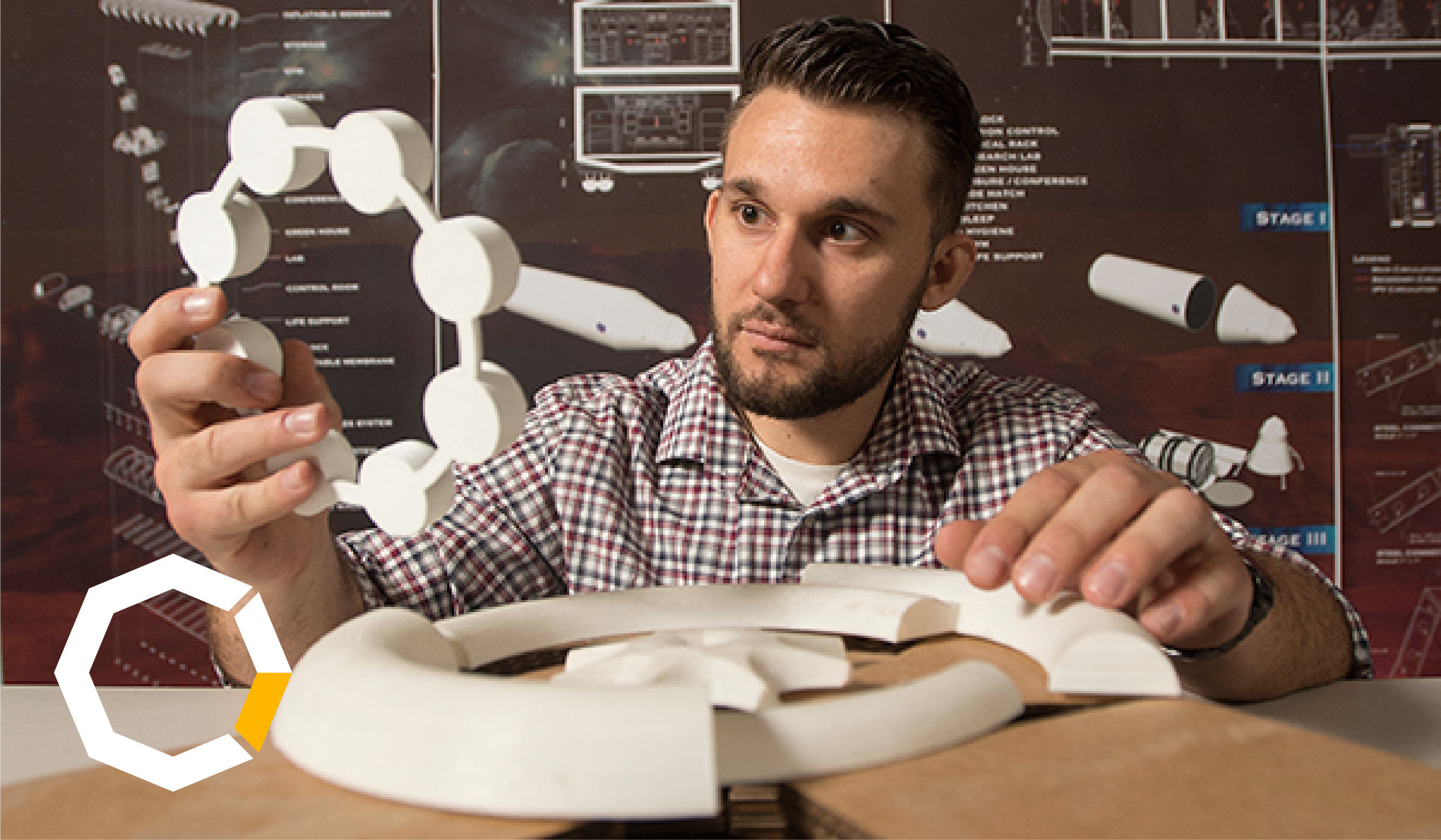 Student holds model of Mars Habitat