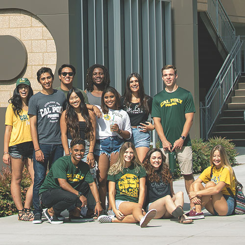 A large group of students poses together in front of Parking Structure 2