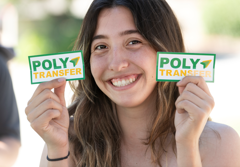 Student holding PolyTransfer stickers