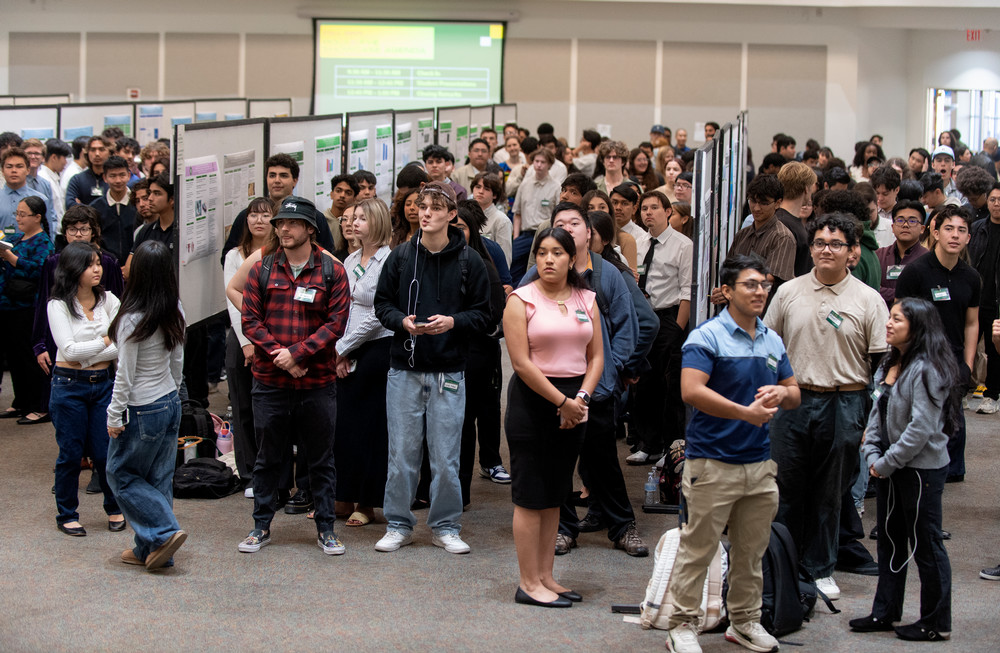 FYE Student sharing her poster project with guests at the PolyX FYE Showcase.