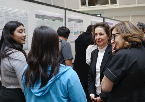 FYE student talking with CPP President, Dr. Iris Levine, and CPP Provost, Dr. Terri Gomez at the PolyX FYE Showcase.