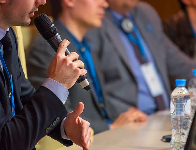 student in suits giving a speech