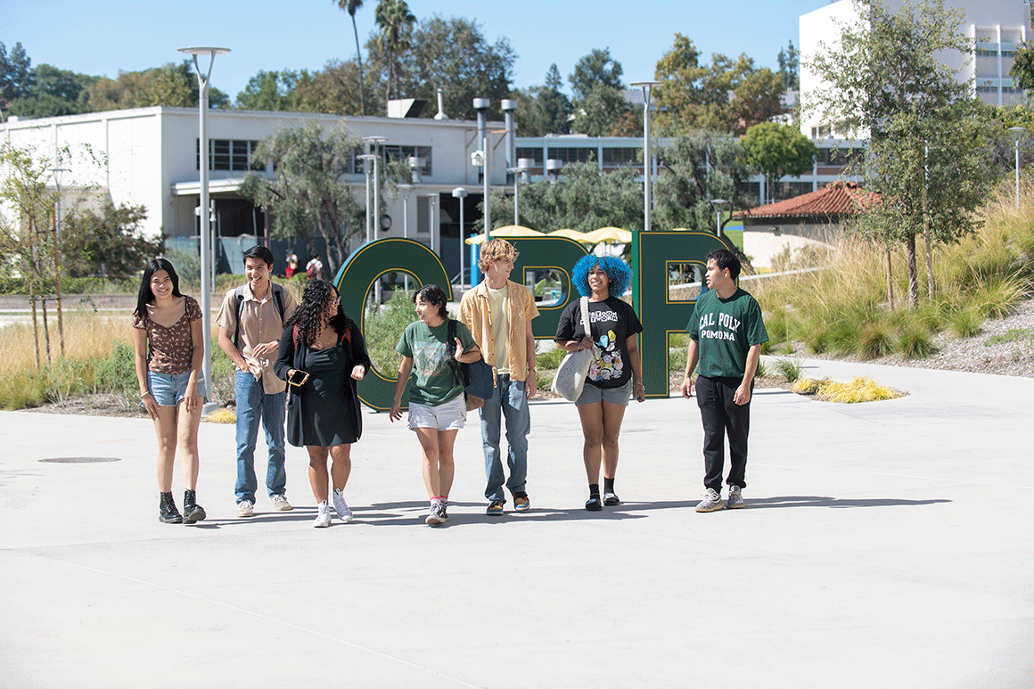A group of students walk and talk in the Park at 98.
