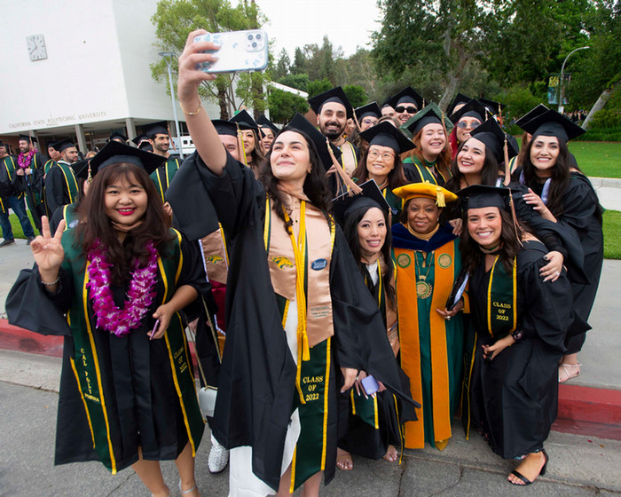 President Coley takes a selfie with Student during an event
