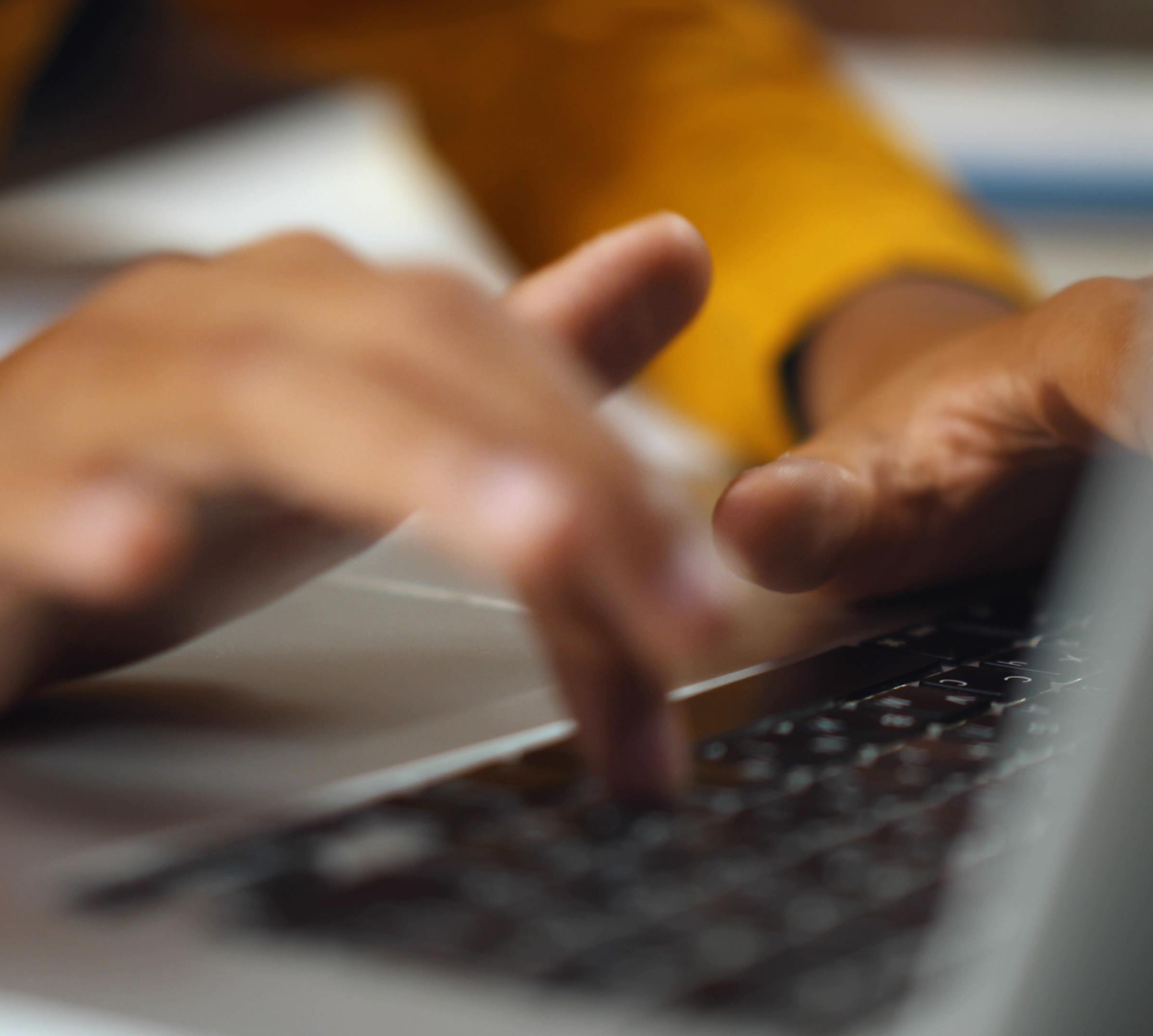 hands typing on a computer