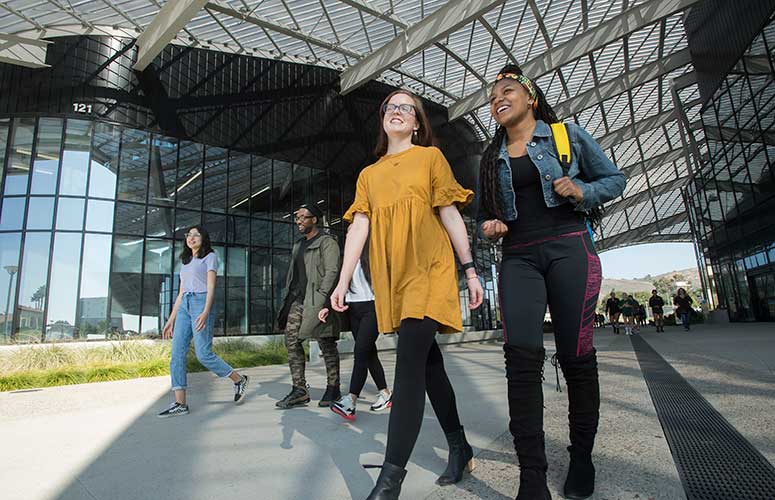 a group of students walking through the SSB breezeway