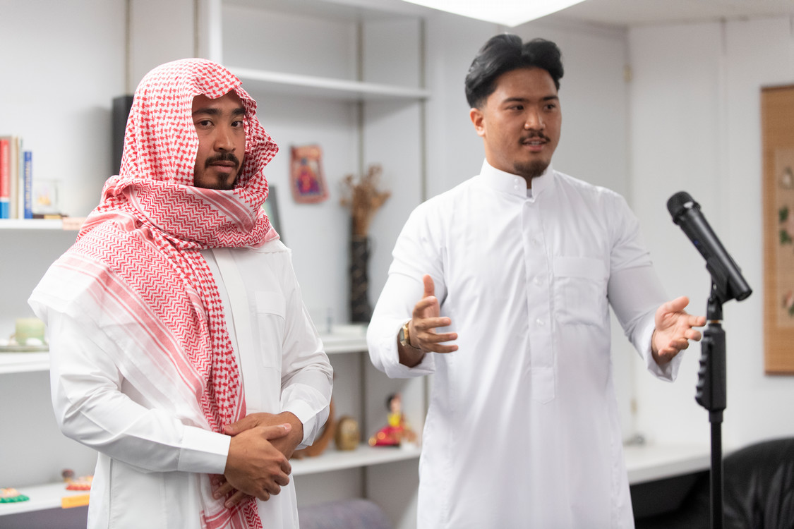 two students demonstrate traditional Arab headress at the Mid-Autumn Festival 