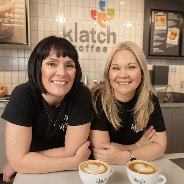 Heather Perry and coffee klatch co-founder next to cups of coffee