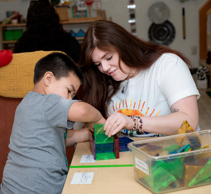 picture of student helping a child play
