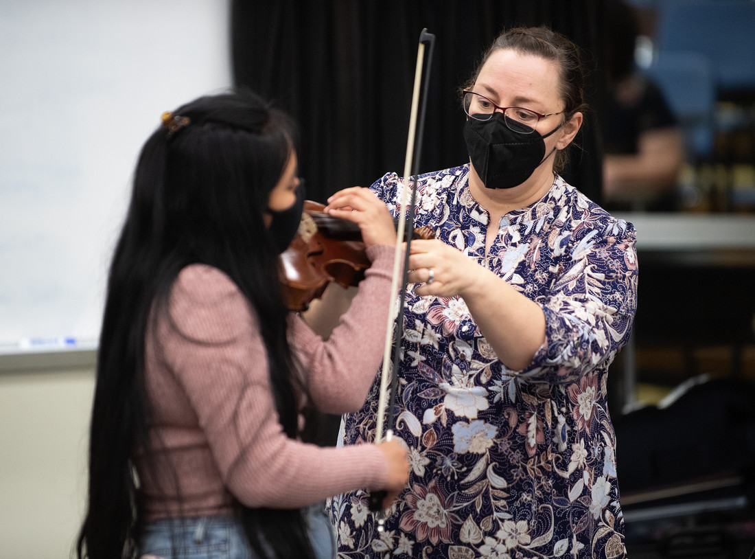 Professor teaching student violin