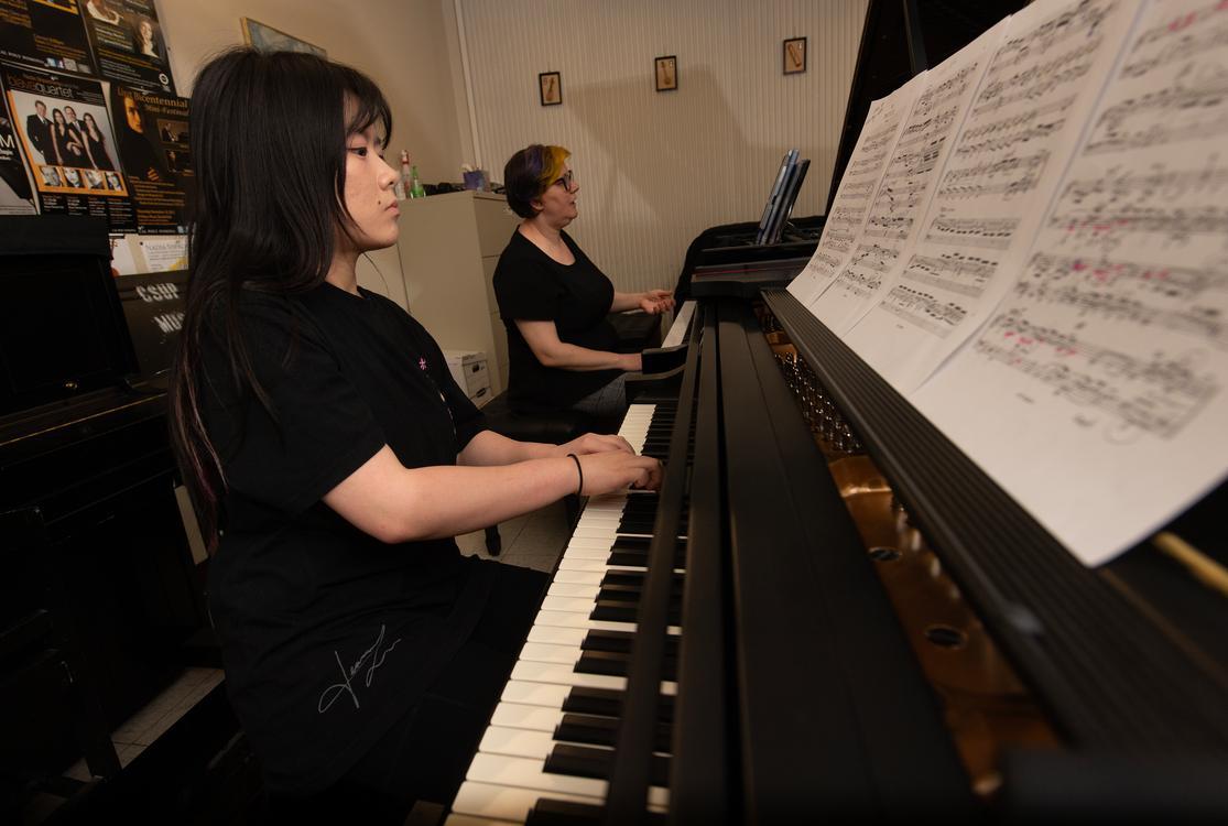 student practicing piano