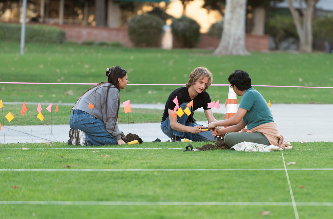 students in the quad searching for objects