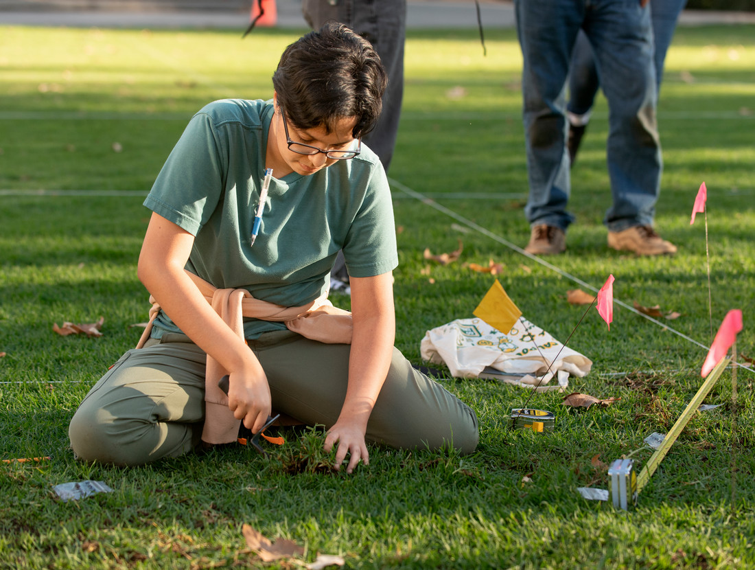 student digging in the ground