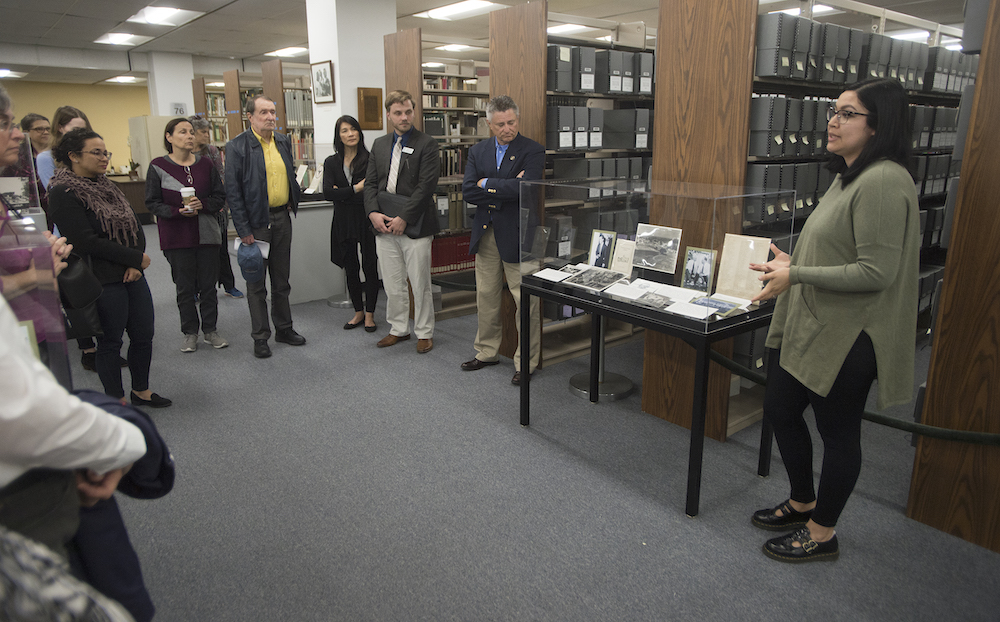 a group of people stand in the CPP archives