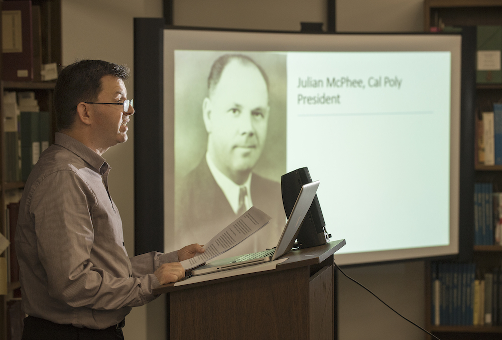 a professor presenting by a podium