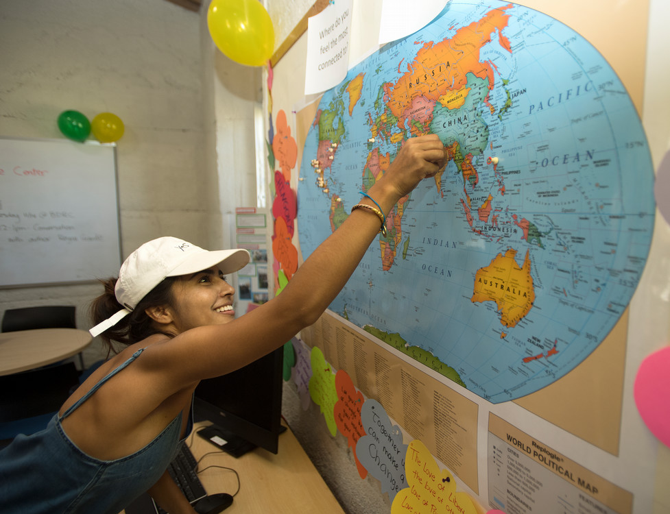 student pointing to map