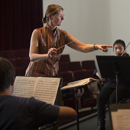 Riveire conducting an orchestra